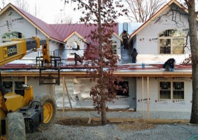 a house being built with a bulldozer and a bulldozer